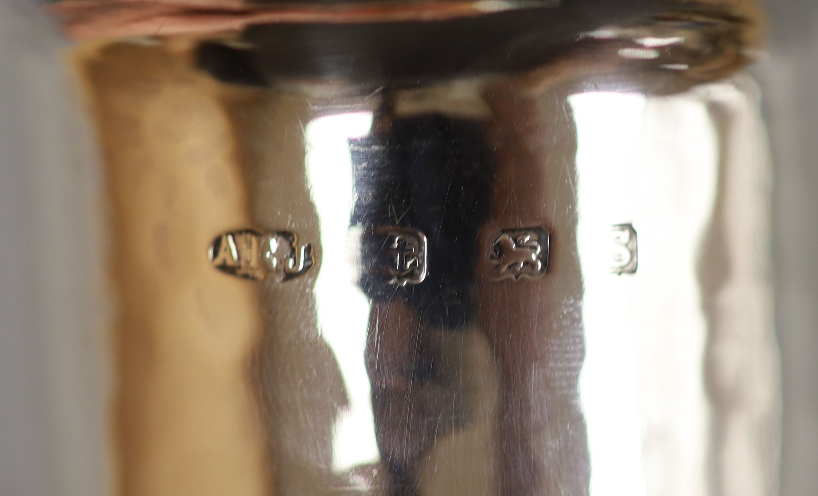 A pair of George V Arts & Crafts silver cylindrical posy vases by Albert Edward Jones, Birmingham, 1917, 14.7cm, 8oz.